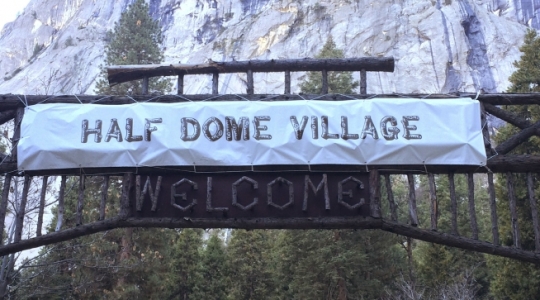 FILE -  In a Tuesday, March 1, 2016 file photo, a sign that used to welcome visitors to Curry Village now reads Half Dome Village, in Yosemite National Park, Calif. The National Park Service has asked a federal trademark board to cancel trademarks, including Curry Village, obtained by Delaware North, the company that previously ran the park's hotels, restaurants and outdoor activities, the Sacramento Bee reported Friday, March 18, 2016. Delaware North, is demanding the park service pay it $51 million for the names and other intellectual property and has filed a lawsuit in federal court. (Rory Appleton/The Fresno Bee via AP, File) LOCAL PRINT OUT (VISALIA TIMES-DELTA, REEDY EXPONENT, KINGBURG RECORDER, SELMA ENTERPRISE, HANFORD SENTINEL, PORTERVILLE RECORDER, MADERA TRIBUNE, THE BUSINESS JOURNAL FRENSO); LOCAL TELEVISION OUT (KSEE24, KFSN30, KGE47, KMPH26); MANDATORY CREDIT